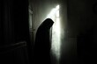 © Cloudyew - Mysterious figure in a dark space with light streaming through window