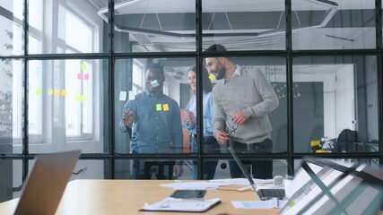 Group of professional workers are in the modern office together.