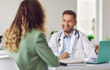 © Studio Romantic - Conversation with doctor. Portrait of friendly male doctor happily listening to his female patient in medical office. Medic looks at woman in front of him. Concept of medicine, healthcare and people.