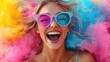 © O - Joyful young caucasian woman in colorful powder explosion with pink and blue sunglasses