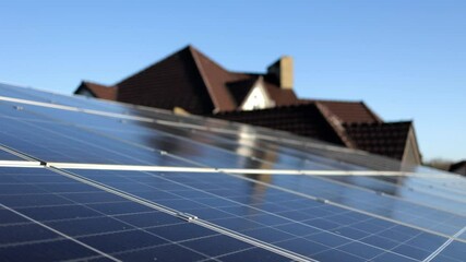 Wall Mural - Close-up of solar panels on a house rooftop with a clear sky. Utilizing photovoltaic technology for clean, renewable energy.