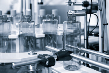 Poster - pharmaceutical industry, medicine pills are filling in the  bottle on production line machine conveyor at the medical factory. selective focus.