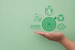 © Pakorn - Environmental goal concept.,Hand holding Dartboard  with reduce co2,net zero emission,ISO 14001 icon concept for climate change,carbon neutrality,greener future.