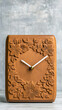 © SJ Studio - Secondhand shop, antique & vintage concept. Wooden clock with floral carvings on a textured background.