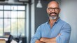 © KKC Studio - Confident Middle-Aged Man Smiling in Modern Office Environment