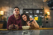 © Miljan Živković - couple man and woman husband wife play console video games at home