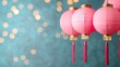 © Arfa_Media - Pink chinese lanterns hanging with turquoise bokeh background representing chinese new year