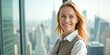 © Radorog. - A businesswoman stands near a panoramic window with a view of the city