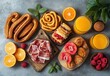 © ANUAR - Delicious Spread of Sweet and Savory Breakfast Treats Including Pastries, Fresh Fruits, Juices, and Meats on a Stylish Gray Background