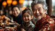 © sompoch - A joyful multigenerational family gathers around a festive table, dressed in elegant traditional Chinese attire, sharing food and laughter, embodying love and togetherness during the Chinese New Year.