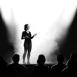 © Rayhanbp - Woman giving a captivating speech on stage, illuminated by spotlights.