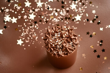 Wall Mural - Christmas festive background with stars confetti, mocha mousse tinting