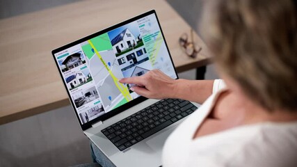 Wall Mural - Woman Using Laptop To Search Online Real Estate Property Listings