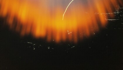 Wall Mural - blurred orange glow in darkness. abstract artistic light streaks against black background evoking fi
