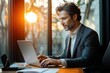 © k - Businessman Working in Modern Office with Laptop and Natural Light