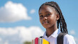 © Ari - Black teenage student girl holding textbook go to school library