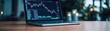 © taweesak - Elegant workspace with laptop displaying stock performance analytics, financial transparency