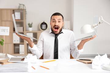 Sticker - Stressed businessman with laptops at table in office