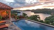 © Pannee - Luxurious outdoor terrace of a villa with an infinity pool, tropical views, and red festive decor under sunrise glow