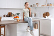 © Pixel-Shot - Teenage girl with orange juice sitting on table in kitchen