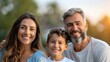 © Vilaysack - A joyful family portrait showcasing a woman, a man, and a young boy smiling together in a natural outdoor setting.