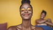 © BOJOShop - Joyful Black Woman with Yellow Eyeshadow Close up Portrait against Yellow Background