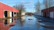 © At My Hat - Flooded parking lot with red & white buildings reflecting in the water. Illustrates neglect, urban decay, or the aftermath of a storm.