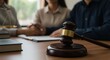 © Muaz - Legal proceedings, wooden gavel in foreground, blurred couple in background, courtroom drama