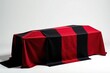 © JKLoma - Black and red striped fabric draped over a coffin, death, funeral, coffin