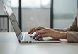 © Anomal - Female hands typing on laptop keyboard at the office. Wide