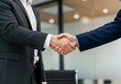 © Anomal - Business partnership meeting. Picture businessmans handshake. Successful businessmen handshaking after good deal. Horizontal, blurred background