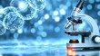 © mahmood - blurred background of a microscope in a lab. Concept of research and cure against cancer, rare diseases and pharmaceuticals. Copy space
