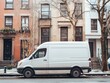 © djatu - White delivery van parked on a city street in front of brownstone buildings.