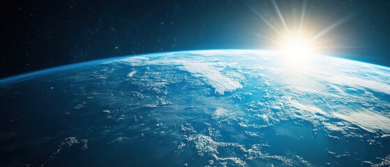 view of earth from space with sunlight illuminating the atmosphere and clouds above the horizon