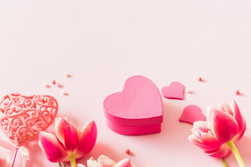 Wall Mural - Pink tulips and hearts on a light pink background