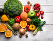 © MdRakibul - Healthy food background. Food photography different fruits and vegetables on white wooden ta