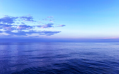 Wall Mural - Ocean calm water and cloudy sky in the evening.