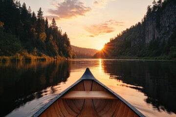 Wall Mural - Sunset view from a canoe on a serene river surrounded by mountains and trees