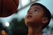 © c80 - Young boy gazes upward with hope as basketball approaches during evening practice at local court