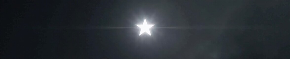 an isolated white star spike against a dark gray backdrop, shine, shimmer