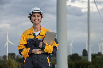 Fototapete - Female engineer wind turbine worker survey operational planning windmill clean renewable energy technology for future. Alternative technology protect environment reduce global warming problems.