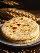 © Scott - indian bread / Chapati / Fulka / Gehu Roti with wheat grains in background. It's a Healthy fiber rich traditional North/South Indian food, selective focus