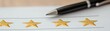 © Chanoknan - A pen next to four golden stars on a paper, symbolizing a review or rating system, often used for feedback evaluation.