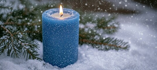 Poster - Blue candle burning in snow with pine branches.
