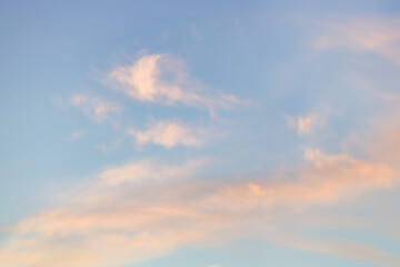 Wall Mural - A beautiful sky tinted by the sun leaving vibrant shades of gold, pink, blue and multicolored. Clouds in the twilight evening and morning sky. Cloudy sky background in the evening, and during the day.