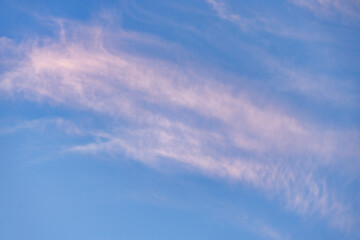 Wall Mural - A beautiful sky tinted by the sun leaving vibrant shades of gold, pink, blue and multicolored. Clouds in the twilight evening and morning sky. Cloudy sky background in the evening, and during the day.