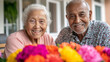 © Bonsales - Cheerful elderly couple smiling joyfully behind vibrant flowers, celebrating their retirement and cherishing moments of togetherness