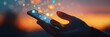© olga_demina - Hand using a smartphone with illuminated social media icons floating above the screen, against a vibrant sunset backdrop, symbolizing the pervasive nature of online connectivity in modern life