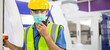 © winnievinzence - Male worker in protective mask talking on walkie-talkie with colleague to control work in front of technology machine at industrial plant factory. copy space