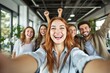 © Pixels Hunter - Group of cheerful young adults taking a selfie indoors with bright smiles and a modern office background.
